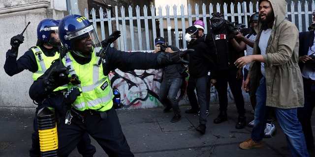 Demonstrators confront with police officers during a Black Lives Matter protest following the death of George Floyd in Minneapolis police custody, at the Waterloo Station in London, Britain, June 13, 2020. (REUTERS/Simon Dawson)