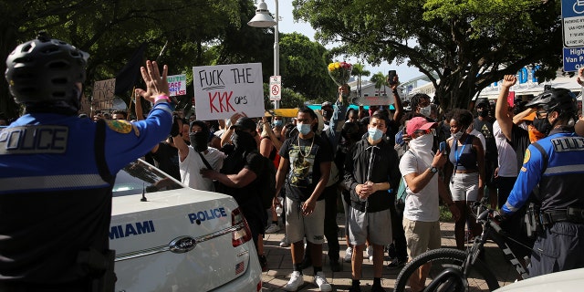 People attend a protest amid nationwide unrest following the death in Minneapolis police custody of George Floyd, in Miami, Florida, U.S., May 31, 2020. REUTERS/Marco Bello - RC220H90OZ67