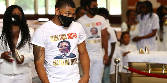 Family members and friends wearing white during a processional for the funeral of Rayshard Brooks at Ebenezer Baptist Church. (Curtis Compton/Atlanta Journal-Constitution via AP, Pool)