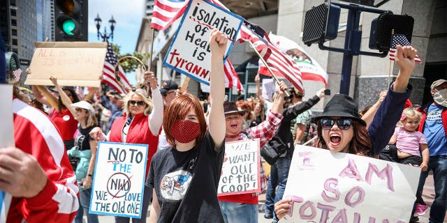 Demonstrators protest during a "Freedom Rally" against Stay-At-Home Directives on April 18, 2020 in San Diego, California.
