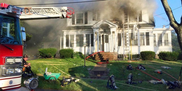 Firefighters battle a house fire in North Andover, Massachusetts, as one of multiple emergency crews responding to a series of gas explosions and fires triggered by a problem with a gas line that feeds homes in several communities north of Boston. (AP Photo)