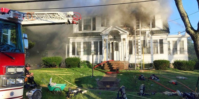 Firefighters battle a house fire in North Andover, Massachusetts, as one of multiple emergency crews responding to a series of gas explosions and fires triggered by a problem with a gas line that feeds homes in several communities north of Boston. (AP Photo)