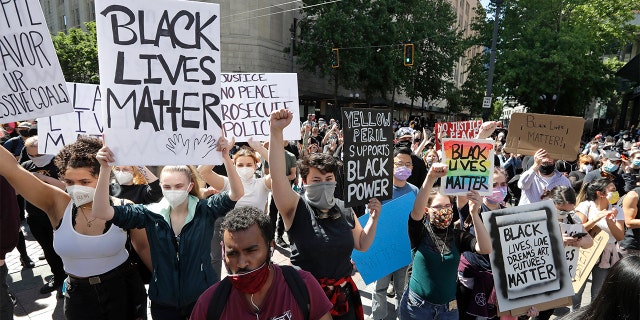 Demonstrators fill a downtown street Monday, June 1, 2020, in Seattle, following protests over the weekend over the death of George Floyd, a black man who was in police custody in Minneapolis. (AP Photo/Elaine Thompson)