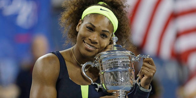 Serena Williams holds the championship trophy after defeating Victoria Azarenka of Belarus in the championship match of the 2012 US Open tennis tournament in New York. 