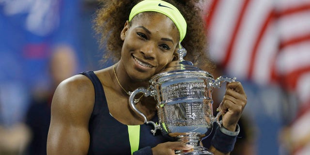 Serena Williams holds the championship trophy after beating Victoria Azarenka, of Belarus, in the championship match at the 2012 US Open tennis tournament in New York. 