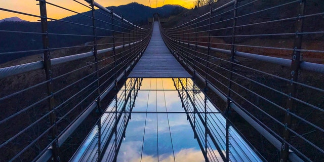 The top layer of one of the three glass panels on the bridge was damaged by a tourist's attempt to slide across them.
