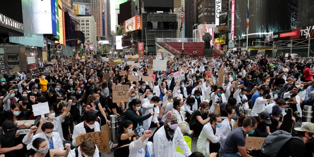 Protesters kneel in Times Square in New York City on Tuesday. One of the city's Democrat councilmembers is claiming Tuesday that "racism" -- and not large, tightly-packed gatherings like these -- would be to blame for any spike in coronavirus cases in the weeks ahead. (AP)