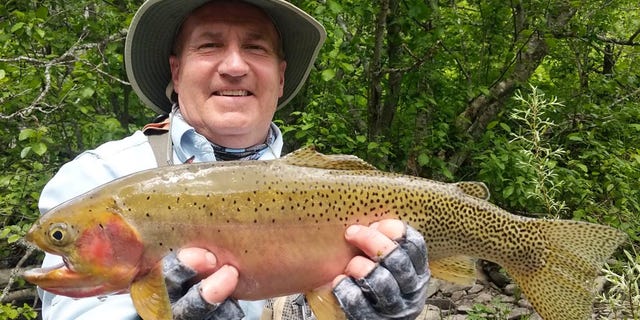 Tom Weadick with his record-breaking, 21-inch Westslope cutthroat trout.