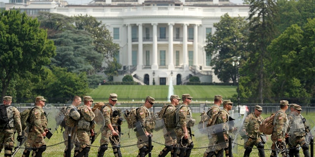 Uniformed military personnel walk in front of the White House ahead of a protest against racial inequality in the aftermath of the death in Minneapolis police custody of George Floyd, in Washington, U.S. June 6, 2020.