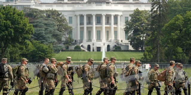 Uniformed military personnel walk in front of the White House ahead of a protest against racial inequality in the aftermath of the death in Minneapolis police custody of George Floyd, in Washington, U.S. June 6, 2020. 