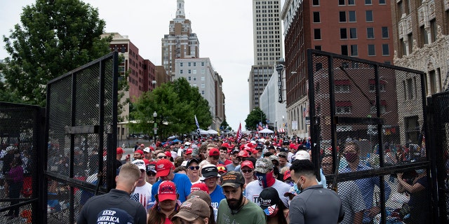 People wait at a security checkpoint to attend a rally with US President Donald Trump later in the evening at the BOK Center on June 20, 2020, in Tulsa, Oklahoma. - Hundreds of supporters lined up early for Donald Trump's first political rally in months, saying the risk of contracting COVID-19 in a big, packed arena would not keep them from hearing the president's campaign message. 