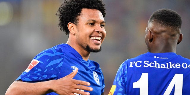 Schalke's Weston McKennie, left, celebrates with Schalke's Rabbi Matondo after scoring his side's opening goal during the German Bundesliga soccer match between Fortuna Duesseldorf and FC Schalke 04 in Duesseldorf, Germany, Wednesday, May 27, 2020. (AP Photo/Martin Meissner, Pool)