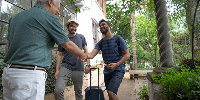 A host welcomes guests at an Airbnb House Rental / Bed and Breakfast Accommodation.
