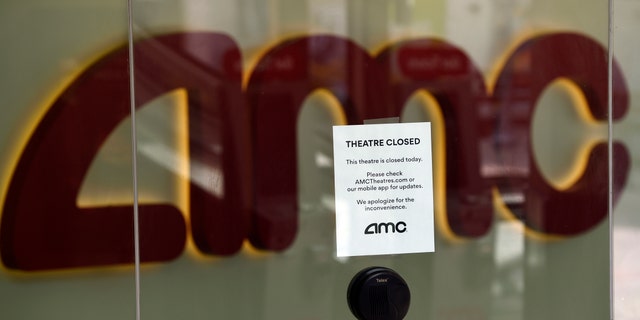 FILE - In this April 29, 2020 file photo, a message on the ticket window at the AMC Burbank 16 movie theaters complex informs potential customers that it is currently closed in Burbank, Calif.