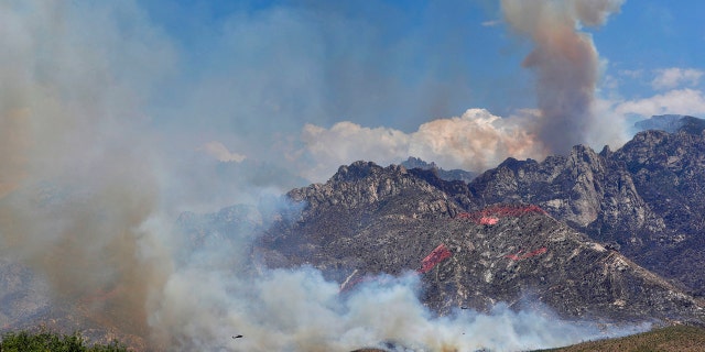 Wildfire air attack crews continue to battle the Bighorn Fire along the western side of the Santa Catalina Mountains, Friday, June 12, 2020, in Oro Valley, Ariz.