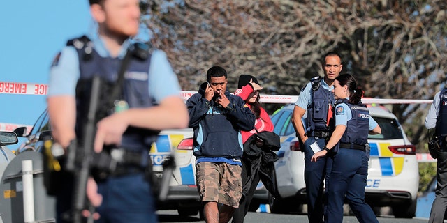 Armed police guard at the scene of a shooting incident following a routine traffic stop in Auckland, New Zealand, Friday, June 19, 2020. New Zealand police say a few officers have been shot and seriously injured and a suspect is on the run. (Michael Craig/New Zealand Herald via AP)