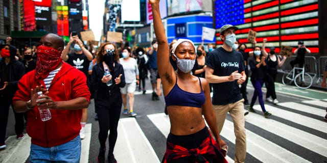 Protesters chant during a solidarity march for George Floyd, Tuesday, June 2, 2020, in Times Square, New York. George Floyd died after being restrained by Minneapolis police officers on May 25. (AP Photo/Eduardo Munoz Alvarez)