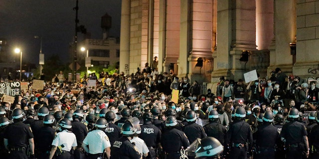 Police block protesters from exiting the Manhattan Bridge in New York, Tuesday, June 2, 2020. New York City extended an 8 p.m. curfew all week as officials struggled Tuesday to stanch destruction and growing complaints that the nation's biggest city was reeling out of control night by night. (AP Photo/Seth Wenig)