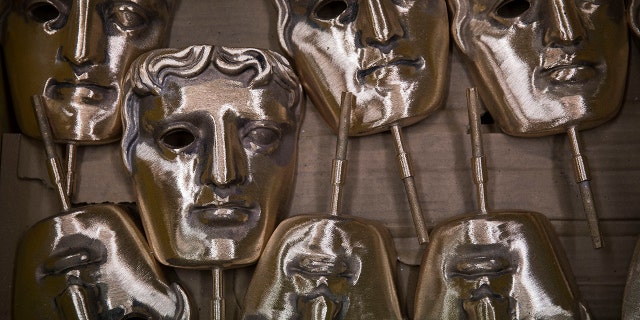 In this Tuesday, Jan. 31, 2020 file photo, bronze alloy masks lie in a foundry in West Drayton, Middlesex, ahead of the awards ceremony in February. (Associated Press)