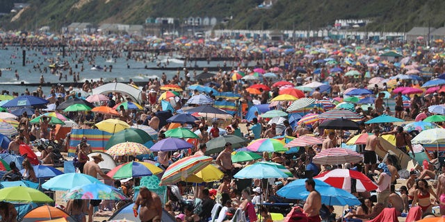 Crowds gather on the beach in Bournemouth as the U.K. experience a heat wave, in Bournemouth, England, on Thursday. (Andrew Matthews/PA via AP)