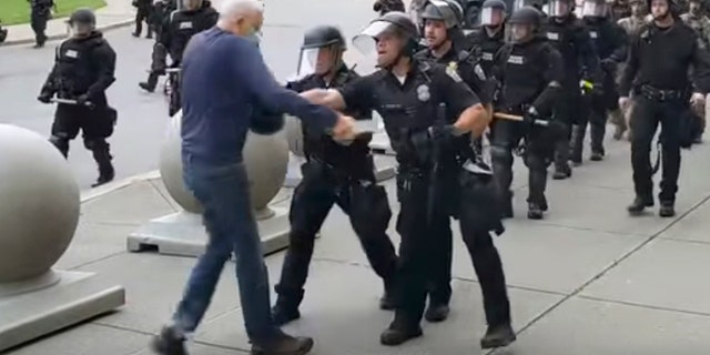 In this image from video provided by WBFO, a Buffalo police officer appears to shove a man who walked up to police June 4, in Buffalo, N.Y. 