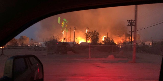 This June 28 photo provided by El Centro Fire Department shows a wildfire burning through an section of Niland, Calif.