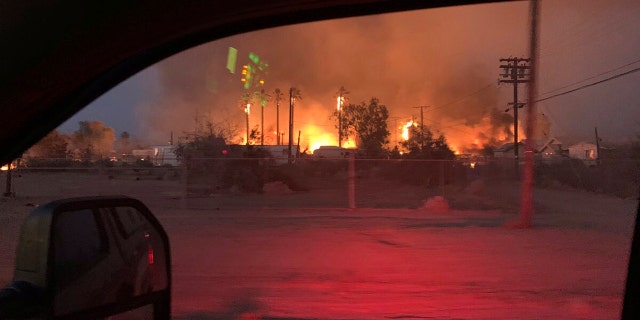 This June 28 photo provided by El Centro Fire Department shows a wildfire burning through an section of Niland, Calif.