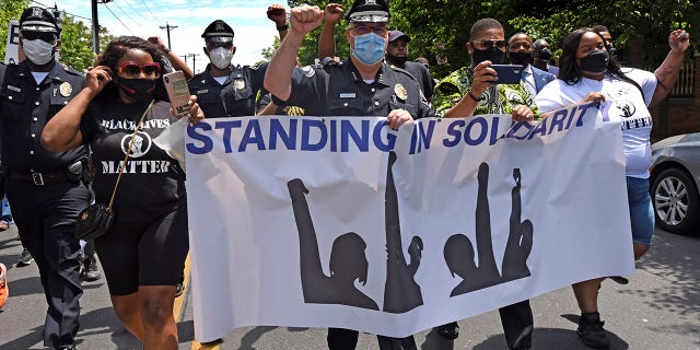 Wysocki, center, raises a fist while marching with Camden residents and activists in Camden, N.J., to protest the death of George Floyd in Minneapolis. (April Saul via AP)