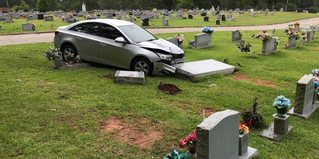 Police say the car plowed into the grave site after it was stolen Saturday. (Carrollton Police Department)