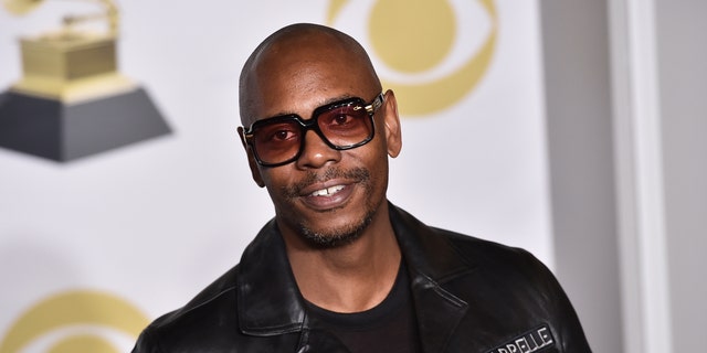 FILE - In this Jan. 28, 2018 file photo, Dave Chappelle poses in the press room with the best comedy album award for "The Age of Spin" and "Deep in the Heart of Texas" at the 60th annual Grammy Awards in New York. Chappelle celebrated George Floyd’s life and ripped the media for the way it handled his death in a surprise Netflix special. The special was released Thursday and is streaming free on Netflix’s comedy YouTube channel.  (Photo by Charles Sykes/Invision/AP, File)