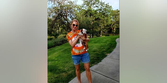 Corrinne Minnard with Elvis the Staffordshire bull terrier puppy. (Credit: SWNS)