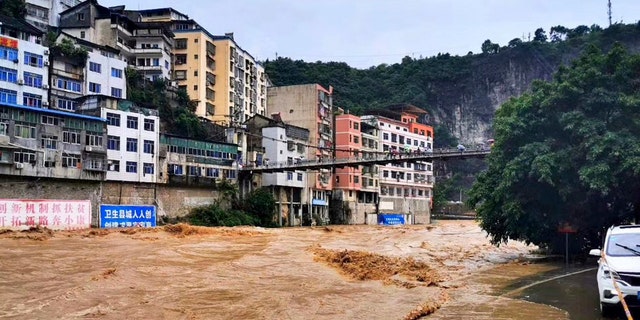 In this photo released by Xinhua News Agency, high flood water passes through Wuxi County in southwestern China's Chongqing on Friday, June 12, 2020.