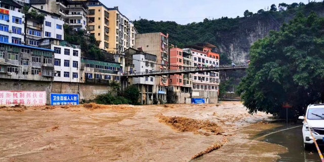 In this photo released by Xinhua News Agency, high flood water passes through Wuxi County in southwestern China's Chongqing on Friday, June 12, 2020.