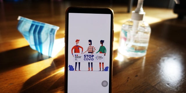 The contact-tracing smartphone app "StopCOVID" is seen on a mobile phone in Paris. A new probe found that some of these apps are not doing enough to ensure user privacy.