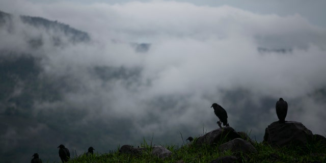Rain clouds hover over mountains in eastern Guatemala, Sunday, as tropical rains slammed the region.