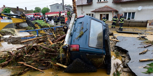 A car is trapped in a flooded area in Brevenec, the part of the village of Sumvald in the Olomouc region, Czech Republic, Monday, June 8, 2020.