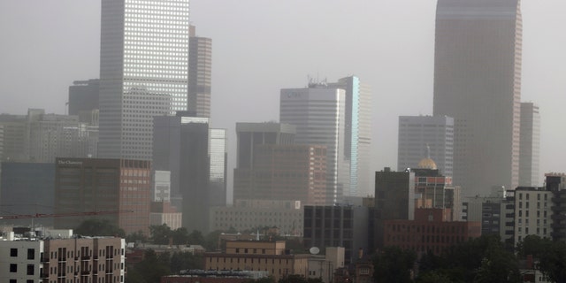 Dust envelopes the skyline of downtown Denver as a derecho moved through the region on Saturday, June 6, 2020.