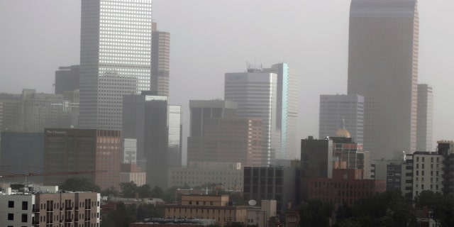 Dust envelopes the skyline of downtown Denver as a derecho moved through the region on Saturday, June 6, 2020.