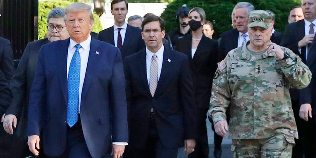 FILE - In this June 1, 2020 file photo, President Trump departs the White House to visit outside St. John's Church, in Washington. Walking behind Trump from left are, Attorney General William Barr, Secretary of Defense Mark Esper and Gen. Mark Milley, chairman of the Joint Chiefs of Staff.. (AP Photo/Patrick Semansky)