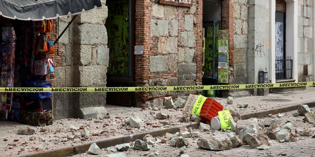 Security tape alert people of a building damaged by an earthquake in Oaxaca, Mexico,Tuesday, June 23, 2020.