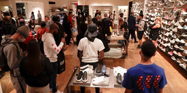Customers walk inside the Selfridges department store in London on Monday. (AP)