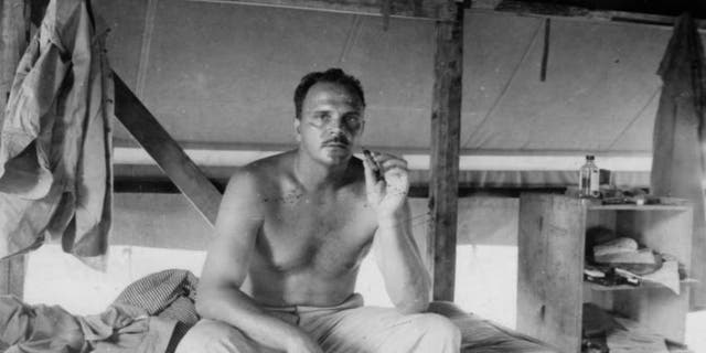 Frank Tachovsky resting on his bunk.