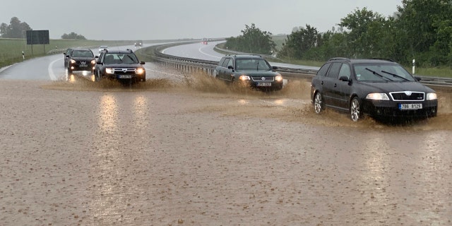Cars drive in heavy rain on the partially flooded Autobahn in Wieselrieth, Germany, June 14. Heavy storms over the weekend caused numerous floods in the district of Neustadt an der Waldnaab.