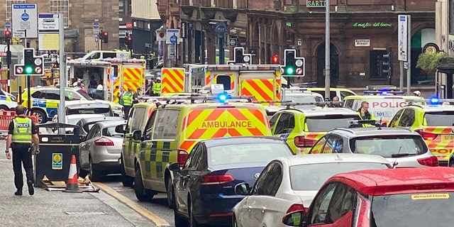Emergency responders are seen near a scene of reported stabbings, in Glasgow, Scotland, Britain June 26, 2020, in this picture obtained from social media. @JATV_SCOTLAND/via REUTERS