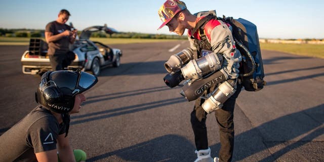 Sam Rogers, 24, lived out a childhood dream and became a real-life Marty McFly when he took to the skies with the help of a 3D-printed jetsuit. Breathtaking footage shows the sci-fi fan flying through the air along an airport runway at sunset while wearing the $432,000 jetpack. (Credit: SWNS)