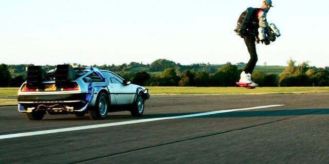 A Back to the Future fan has recreated an iconic cinematic moment alongside a DeLorean time machine -- after designing the world's first flying overboard. (Credit: SWNS)