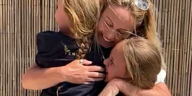 "Mummy! Mummy!" the girls shrieked in surprise, as the family embraced with hugs and tears after over two months apart.