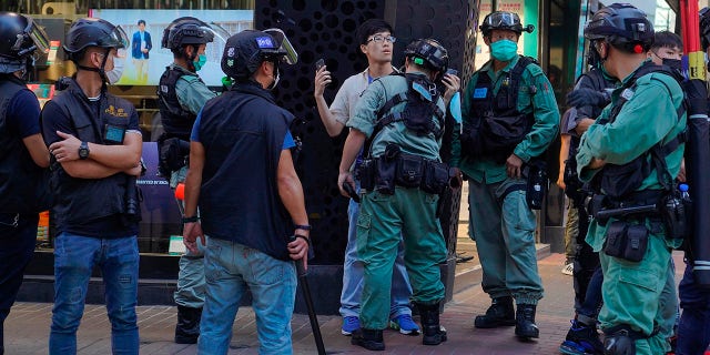 Police detain a person during a pro-democracy rally supporting human rights and to protest against Beijing's national security law in Hong Kong on Sunday. (AP Photo/Vincent Yu)