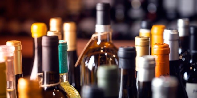 Bottles of alcohol sit together in a group.