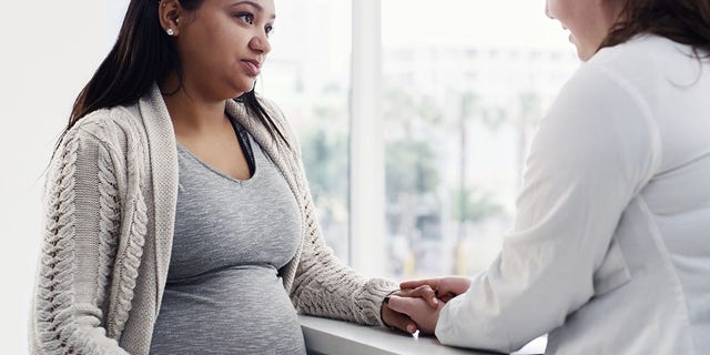 Pregnant woman receives medical counseling. Prenatal screening may not provide the diagnostic accuracy that parents-to-be want. 